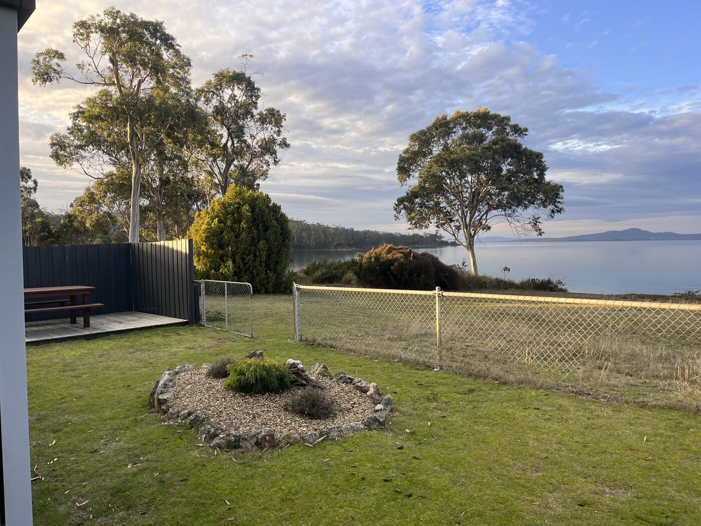 Lawn and outdoor seating looking toward the bay