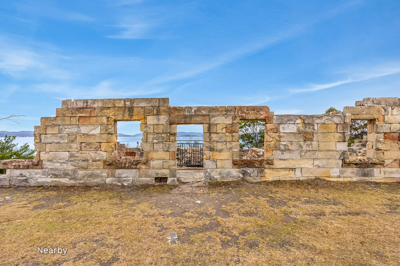 Sandstone ruins at Coal Mines Historic Site with a bay view through the doorway